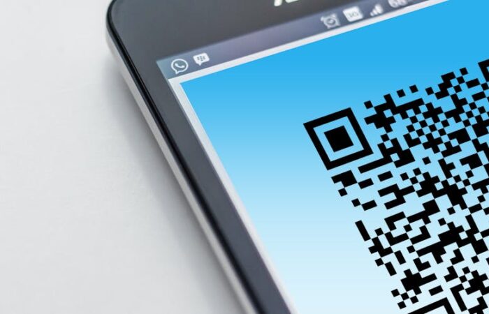 Close up of a smart packaging label with scannable QR code glowing under NFC activation showing AR overlay on a smartphone screen displaying product info and recycling instructions futuristic tech vibe