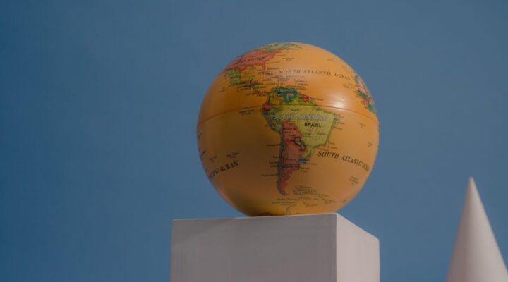 Flat lay comparison of custom printed mailer envelopes and rigid corrugated boxes with international shipping labels on a world map background