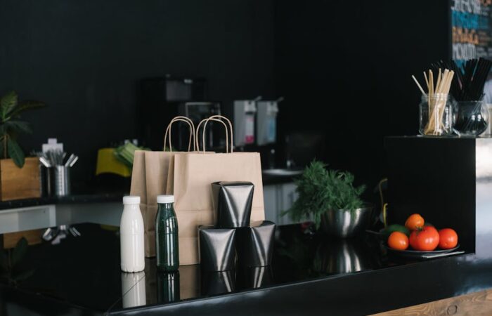 collage of modern sustainable packaging including paper boxes bioplastic films and recyclable mailers with eco icons