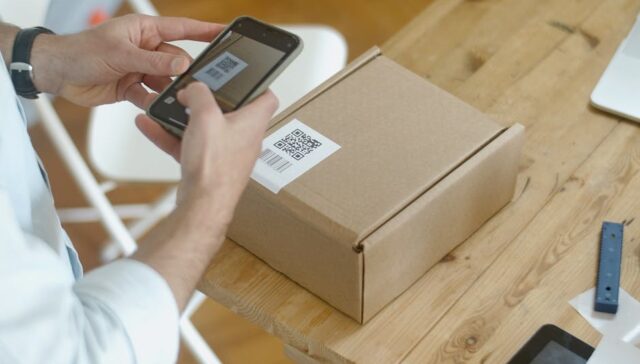 Modern senior friendly pharmaceutical blister pack with easy open tabs large high contrast labels and QR code for instructions held by elderly hands demonstrating ease of use