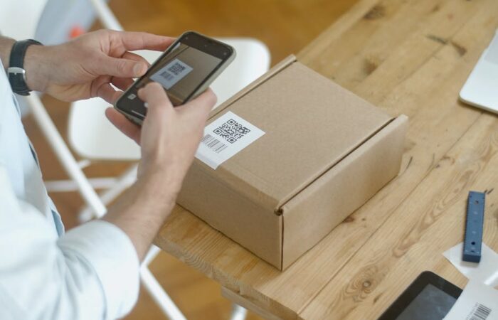 Modern senior friendly pharmaceutical blister pack with easy open tabs large high contrast labels and QR code for instructions held by elderly hands demonstrating ease of use