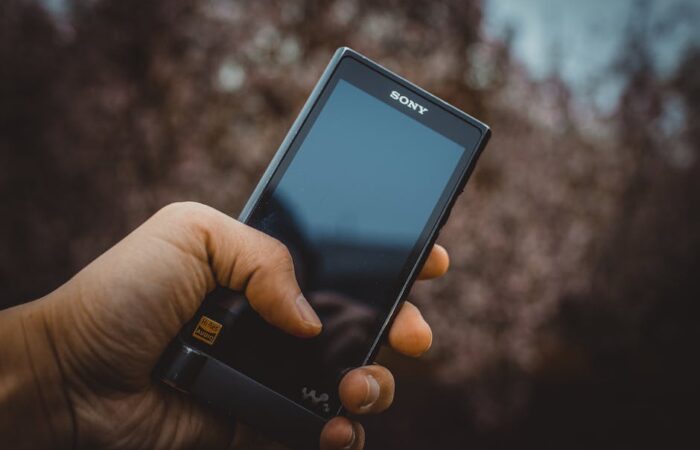 Modern senior friendly pill bottle with ergonomic grip ridges large high contrast labels and easy open mechanism held by an elderly hand demonstrating ease of use