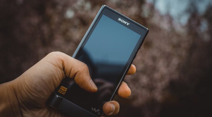 Modern senior friendly pill bottle with ergonomic grip ridges large high contrast labels and easy open mechanism held by an elderly hand demonstrating ease of use