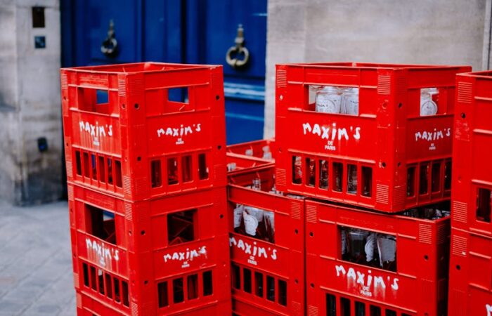 Vibrant cityscape at dusk with delivery trucks e commerce packages stacked on sidewalks and diverse urban consumers unboxing branded products emphasizing fast paced urban delivery and customization