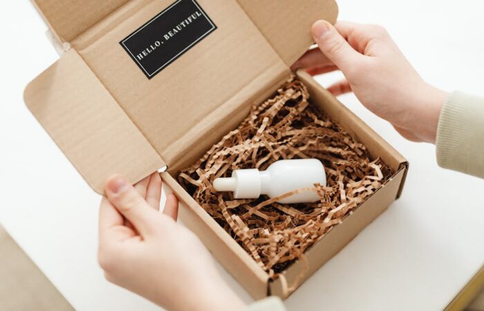 Vibrant unboxing scene of a custom printed mailer box for a DTC beauty subscription showing colorful branding product reveal and excited customer hands